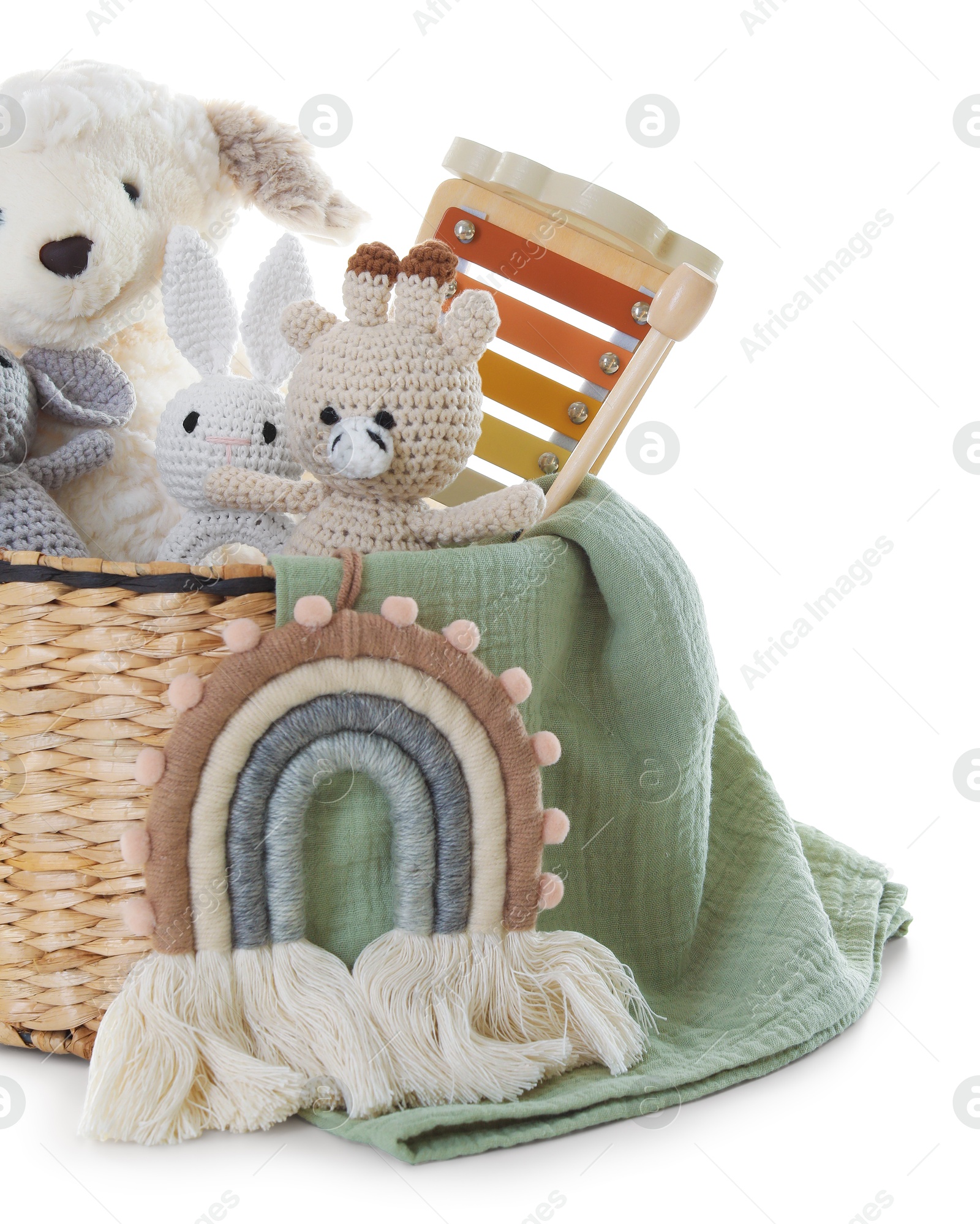 Photo of Different toys in wicker basket isolated on white