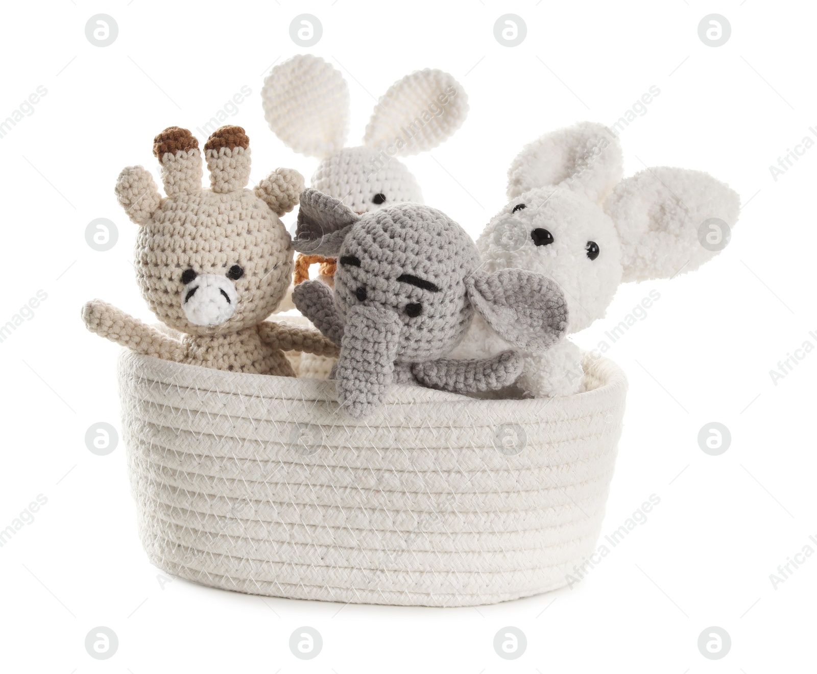 Photo of Different soft toys in wicker basket isolated on white