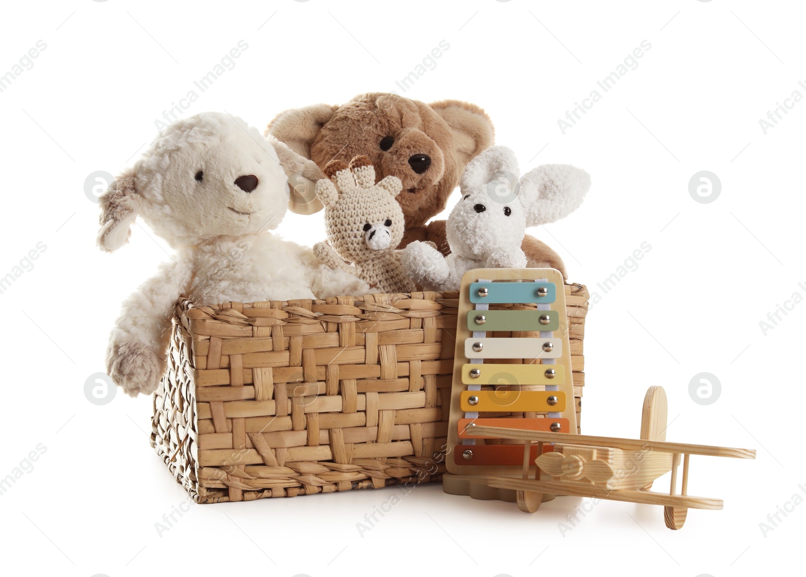 Different toys in wicker basket isolated on white Photo of Different toys in wicker basket isolated on white