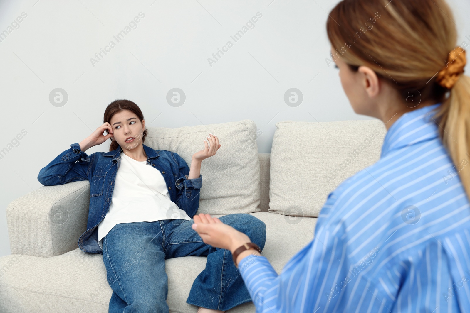 Photo of Professional psychologist working with teenage girl in office