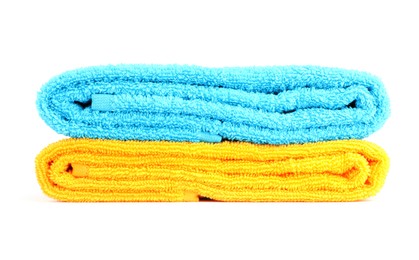 Photo of Stack of bright terry towels isolated on white