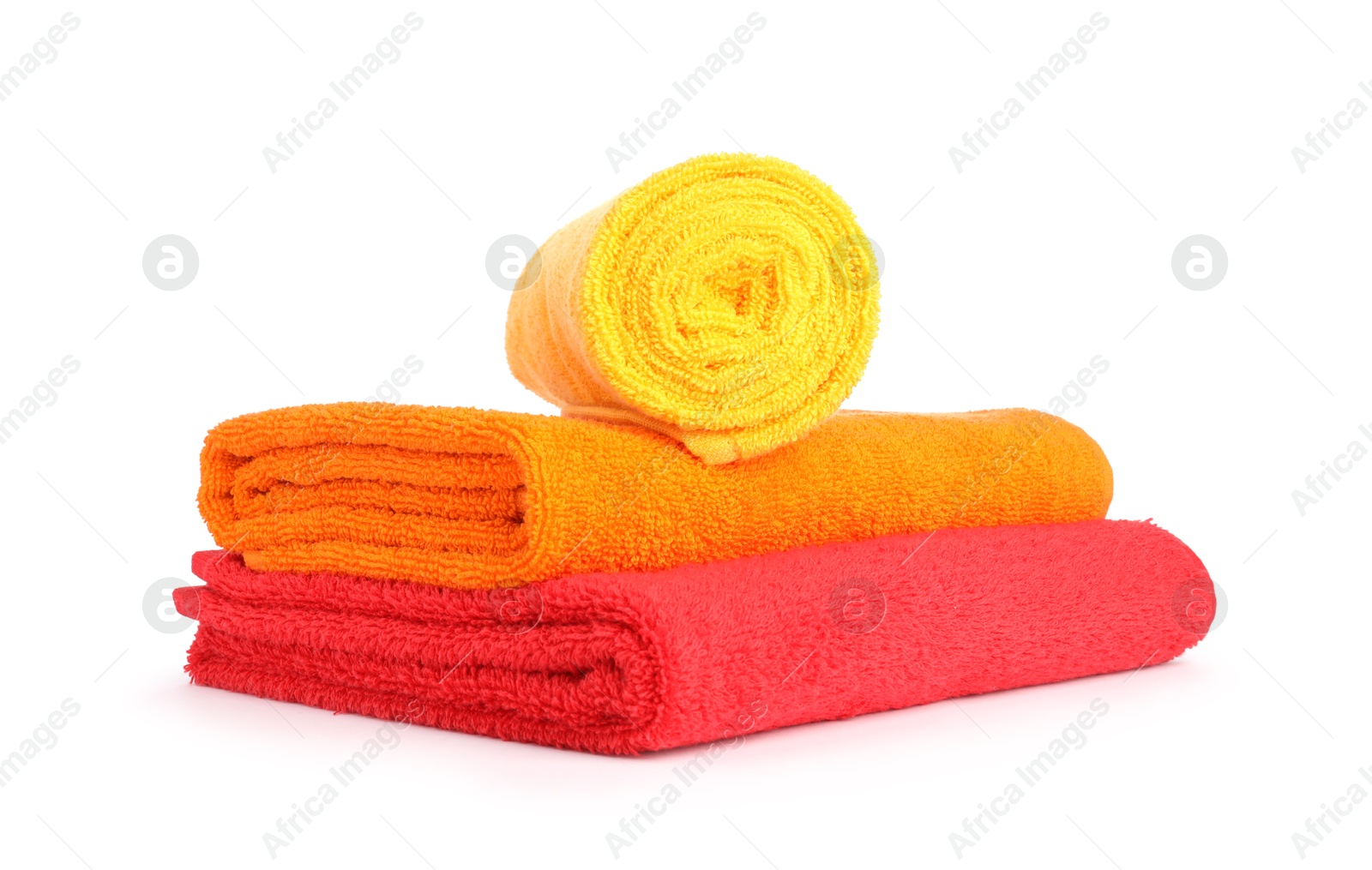 Photo of Stack of bright terry towels isolated on white