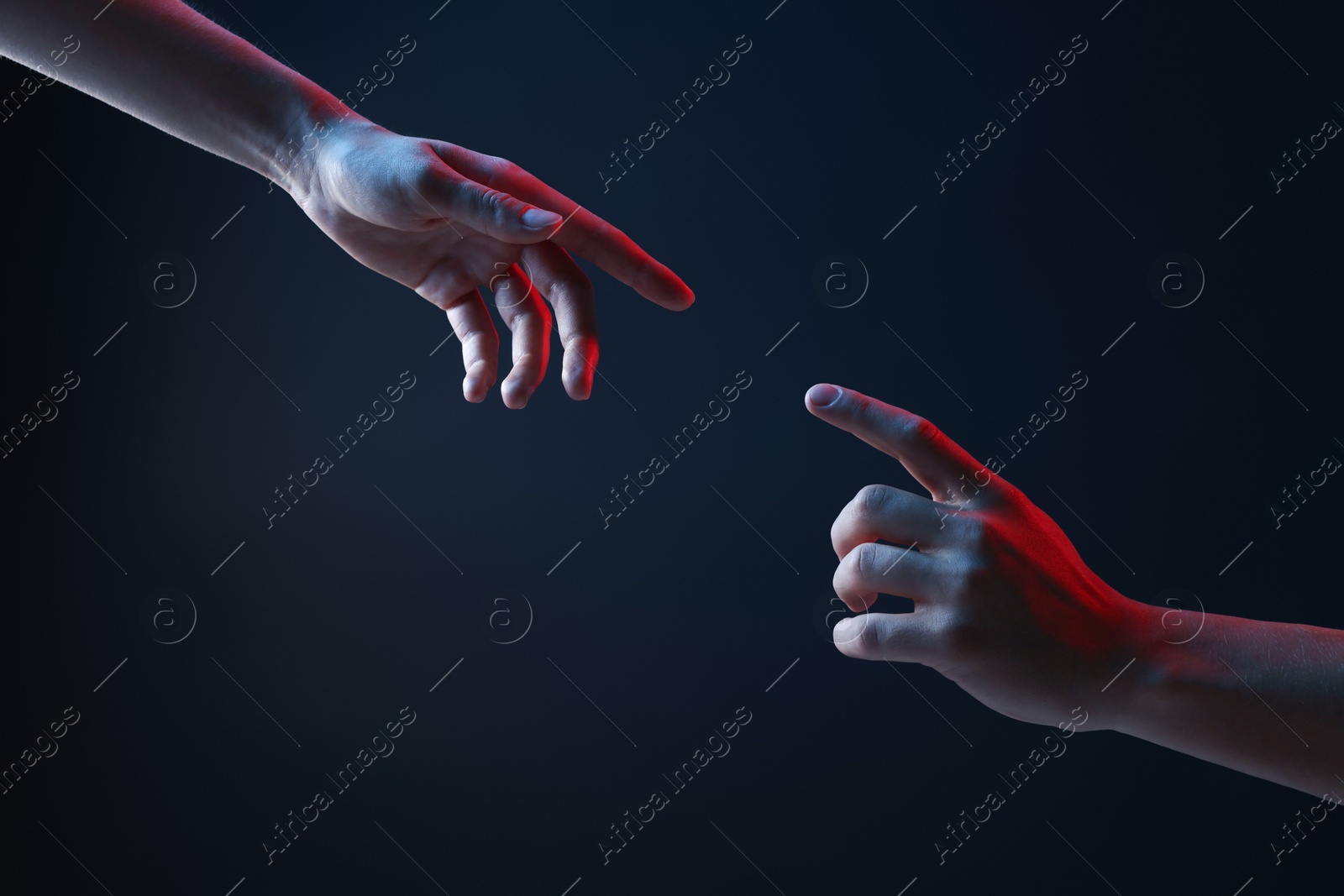 People joining hands on dark blue background, closeup Photo of People joining hands on dark blue background, closeup