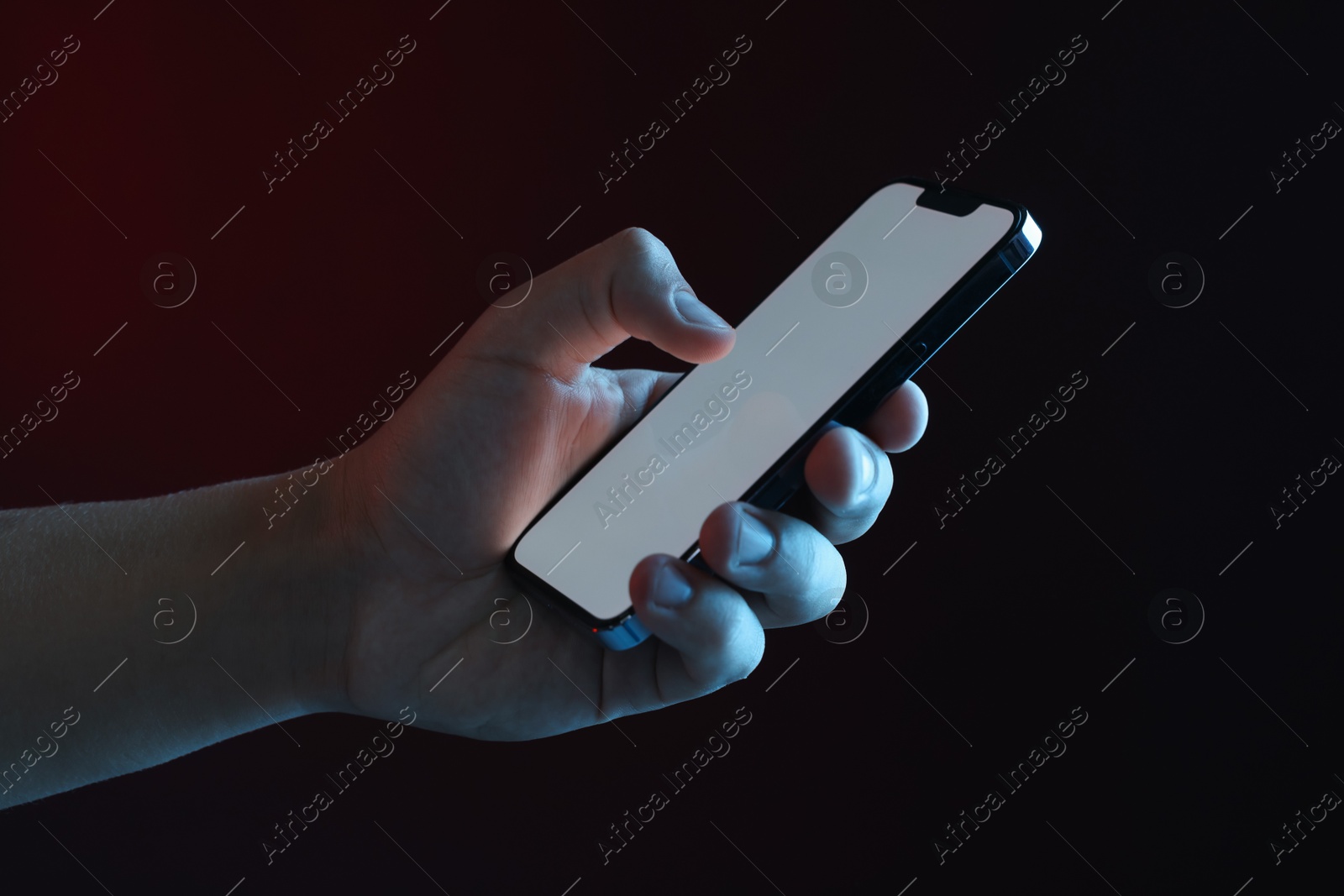 Photo of Man with modern smartphone on black background, closeup. Mockup for design
