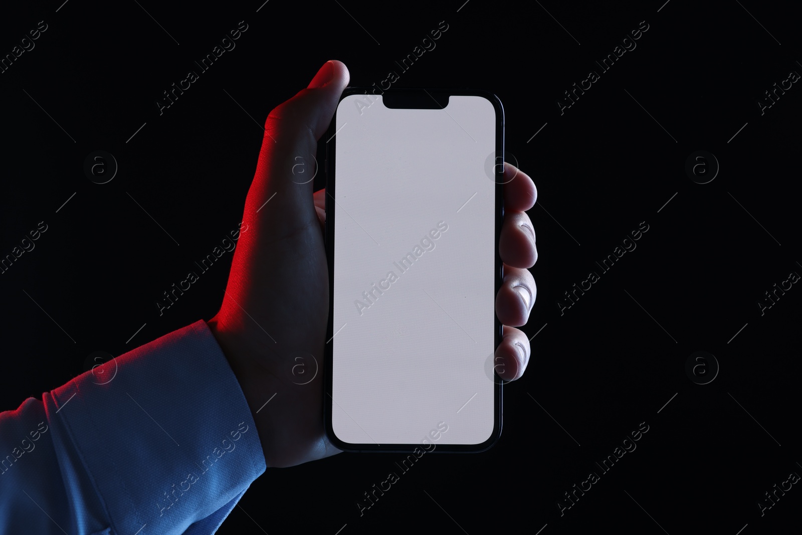 Photo of Man with modern smartphone on black background, closeup. Mockup for design
