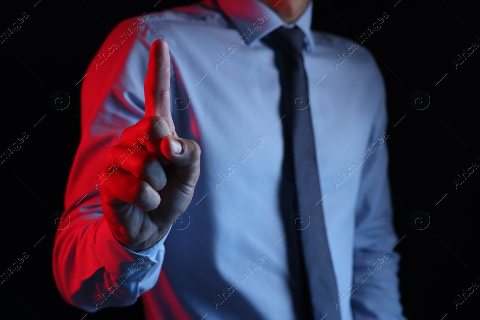 Photo of Man touching something on black background, closeup