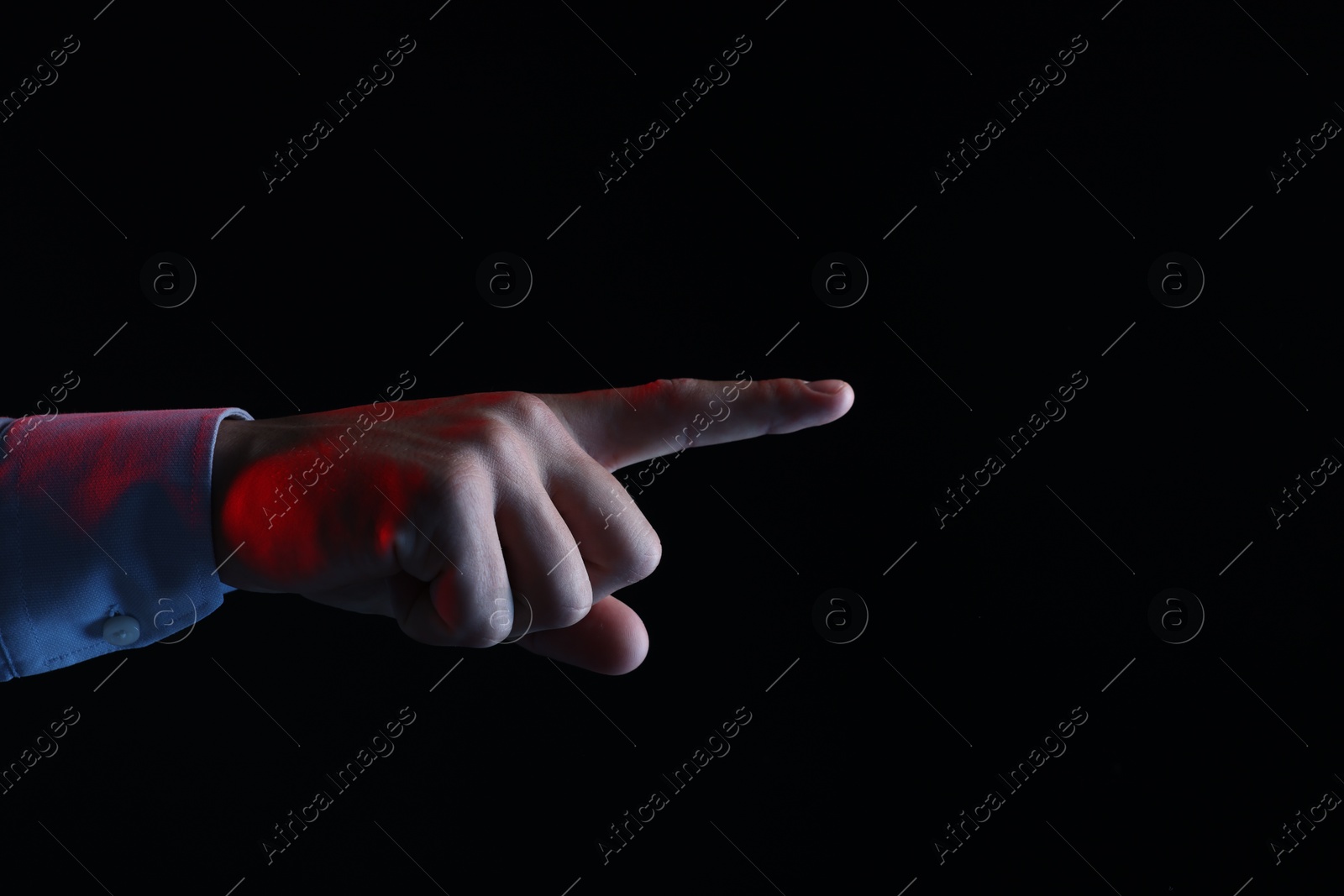 Photo of Man touching something on black background, closeup. Space for text