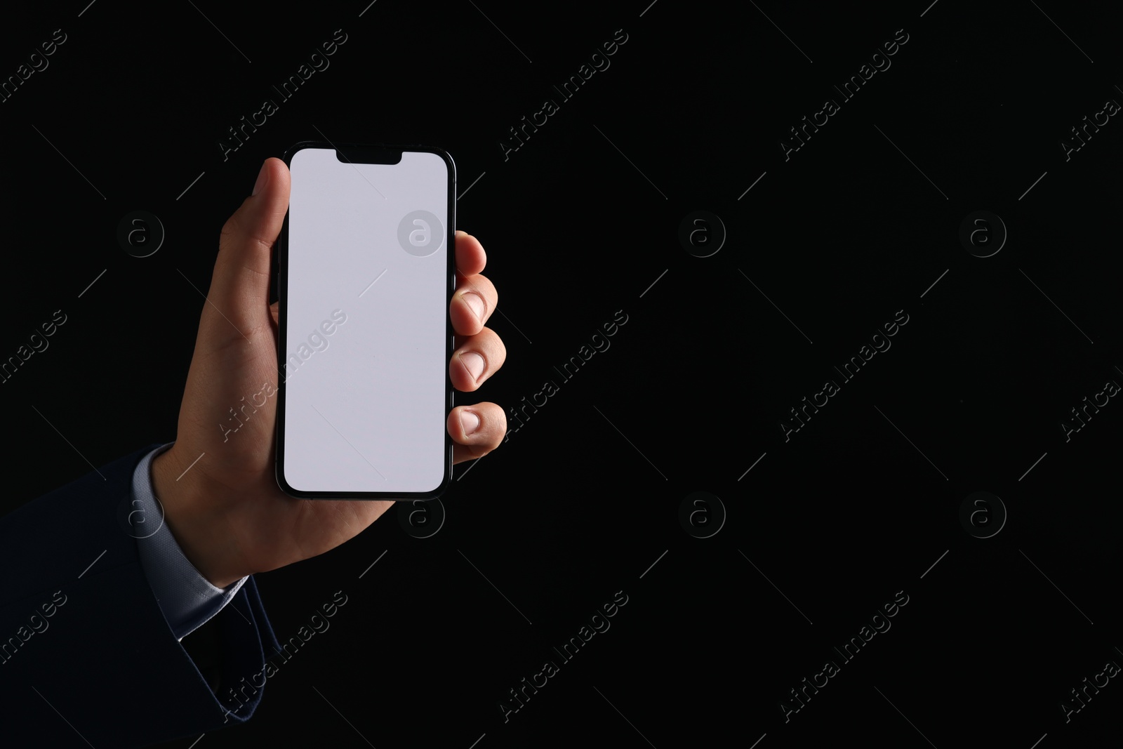Photo of Man with modern smartphone on black background, closeup. Mockup for design