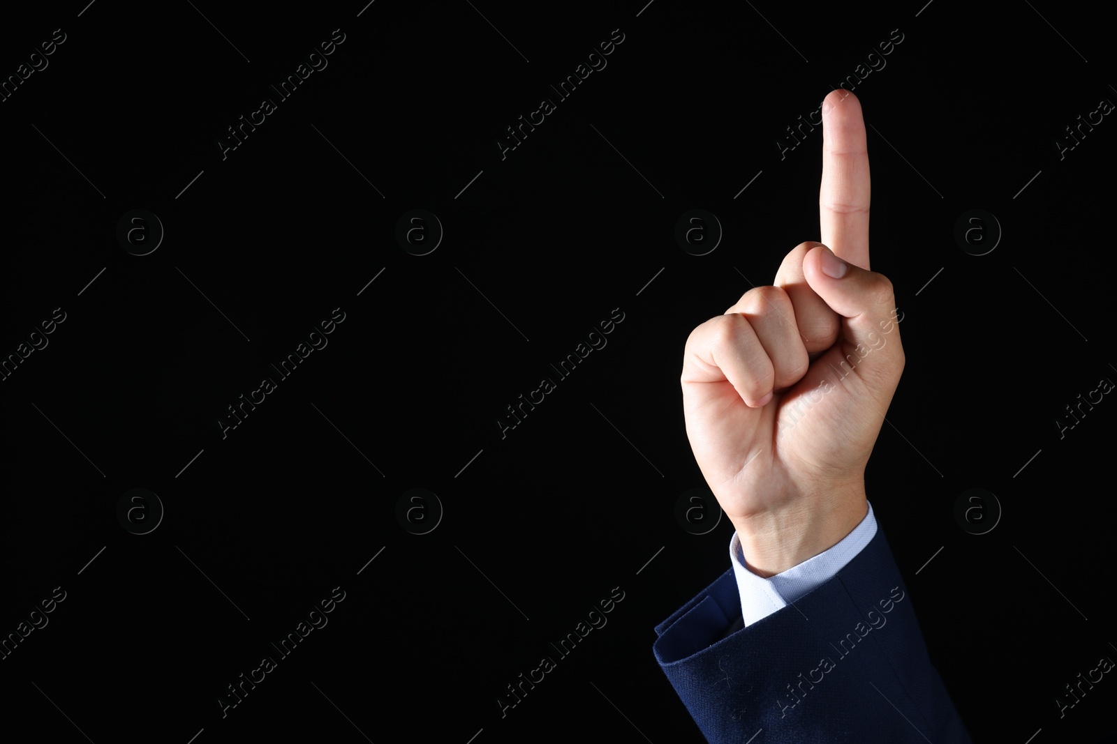 Photo of Man touching something on black background, closeup. Space for text
