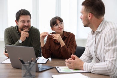 Photo of Couple having meeting with business consultant at table in office