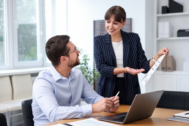 Photo of Consultant working with client at table in office. Business meeting