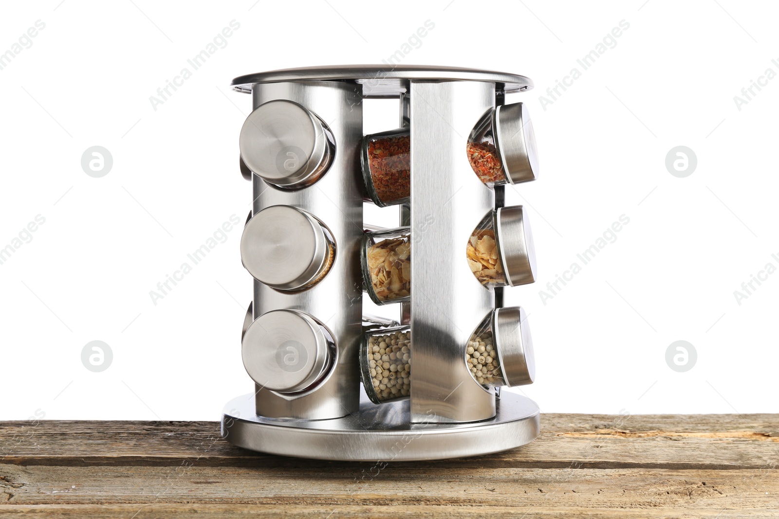 Photo of Many different aromatic spices in glass jars on wooden table against white background