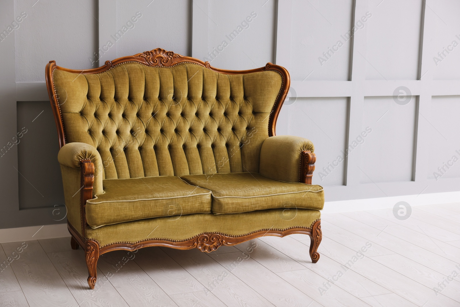 Photo of Stylish sofa near gray wall in room