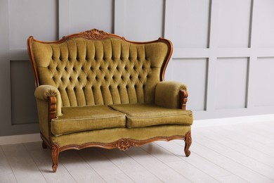 Photo of Stylish sofa near gray wall in room