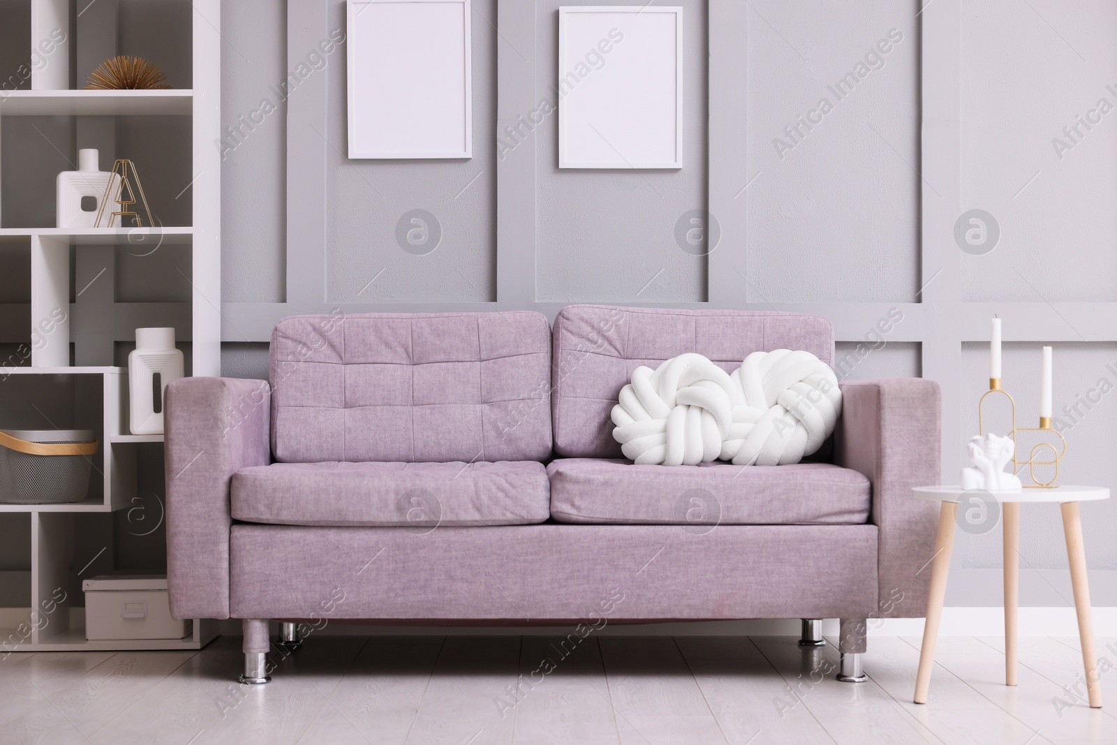 Photo of Comfortable gray sofa with cushions indoors. Interior design
