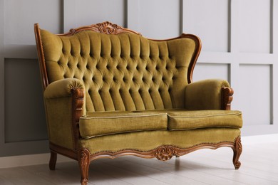 Photo of Stylish sofa near gray wall in room