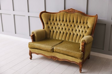 Photo of Stylish sofa near gray wall in room