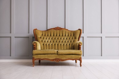 Photo of Stylish sofa near gray wall in room