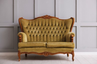 Photo of Stylish sofa near gray wall in room