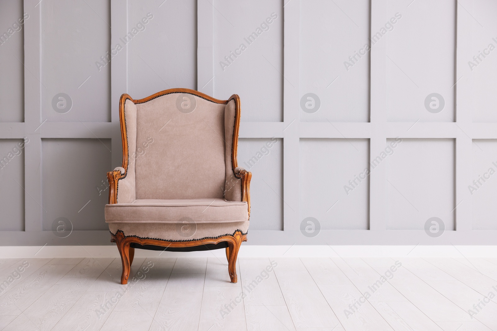 Photo of Stylish armchair and decor near gray wall in room. Space for text