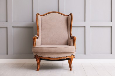Photo of Stylish armchair and decor near gray wall in room