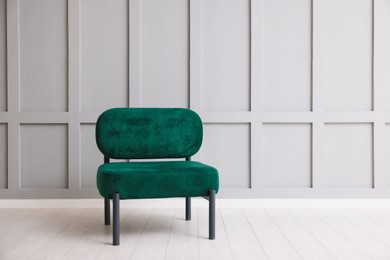 Photo of Stylish armchair near gray wall in room. Space for text