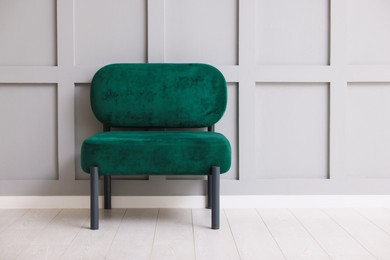 Photo of Stylish armchair near gray wall in room. Space for text