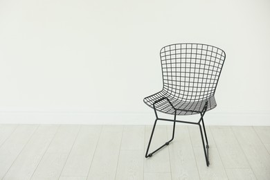 Photo of Stylish metal chair in room, space for text