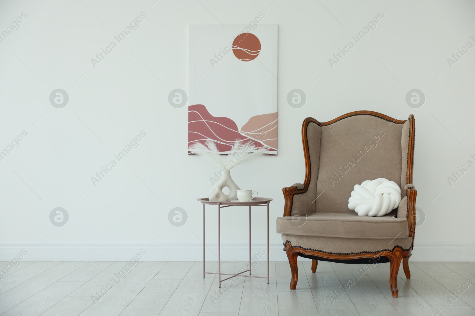 Photo of Stylish armchair with cushion and other decor near white wall indoors, space for text. Interior design