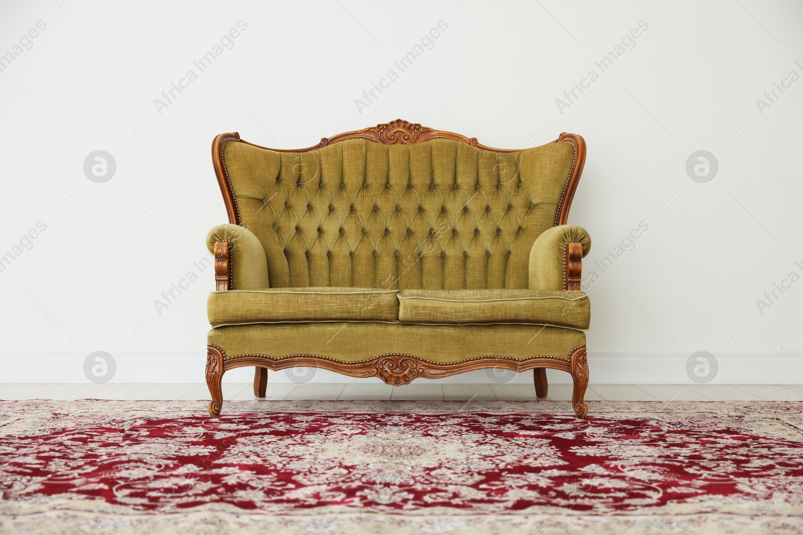 Photo of Stylish sofa near white wall in room