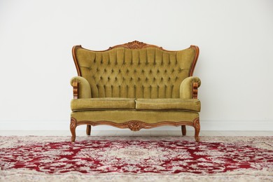 Photo of Stylish sofa near white wall in room