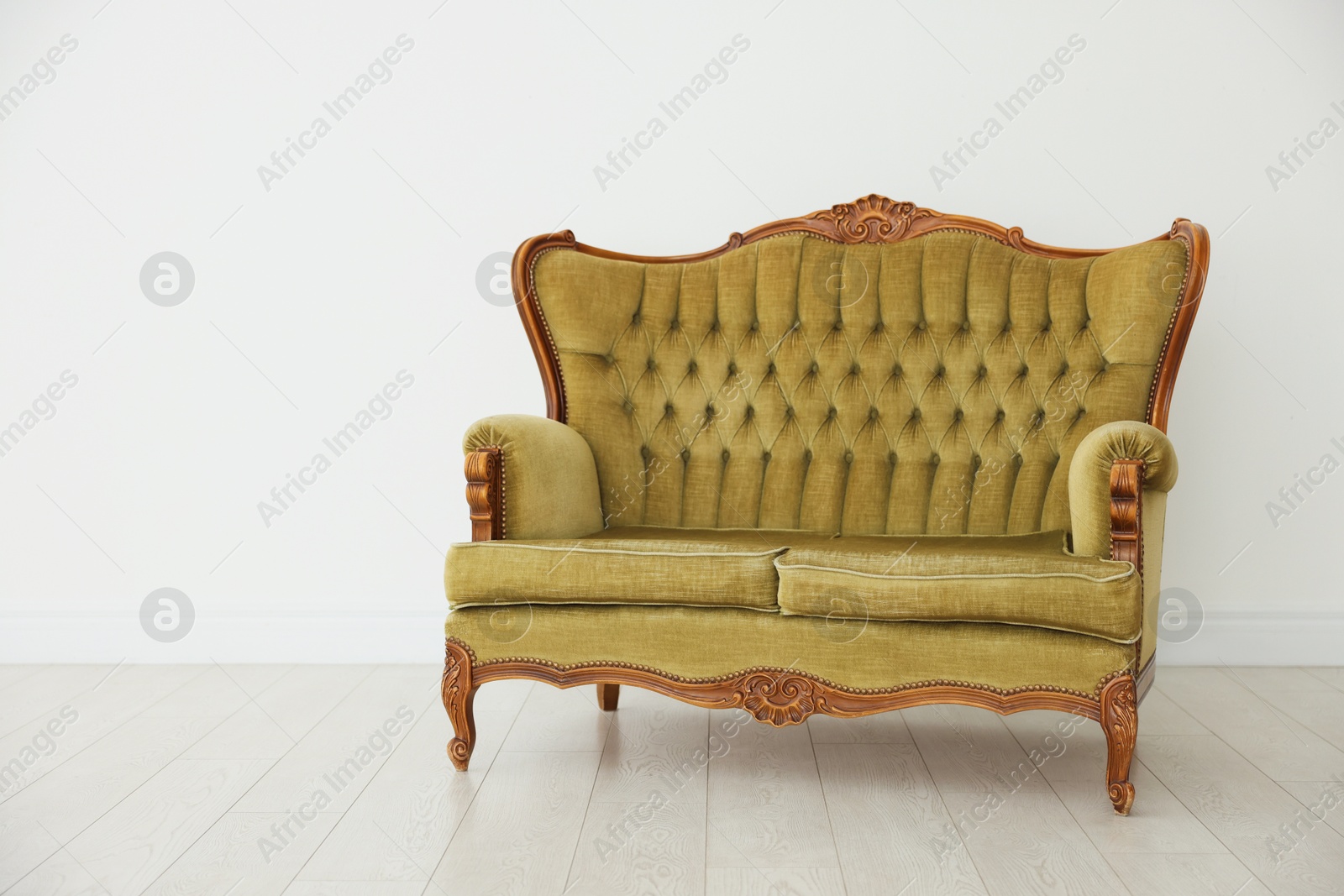 Photo of Stylish sofa near white wall in room