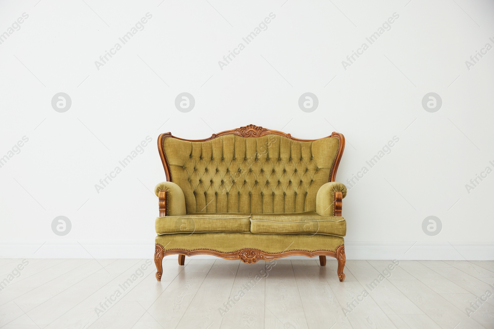 Photo of Stylish sofa near white wall in room