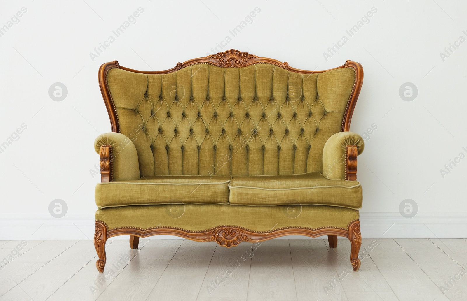 Photo of Stylish sofa near white wall in room