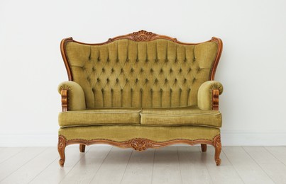 Photo of Stylish sofa near white wall in room