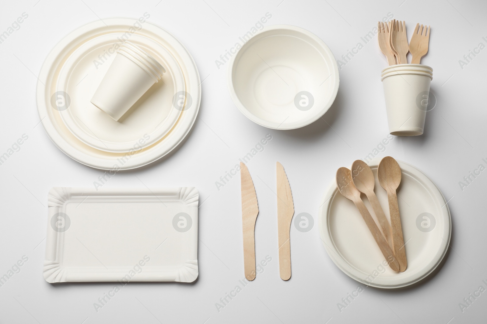 Photo of Set of disposable tableware on white background, flat lay