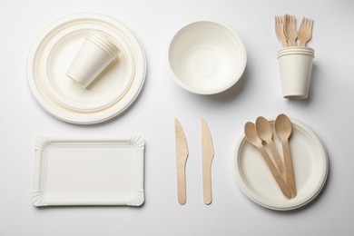 Photo of Set of disposable tableware on white background, flat lay