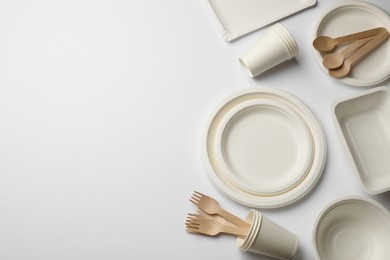 Photo of Set of disposable tableware on white background, flat lay. Space for text