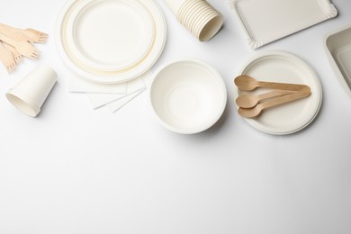 Photo of Set of disposable tableware and napkins on white background, flat lay