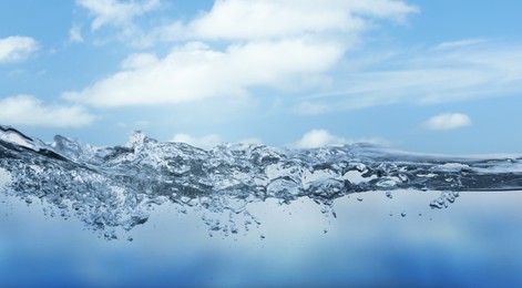 Image of Sea water surface and underwater view. Sky with clouds above