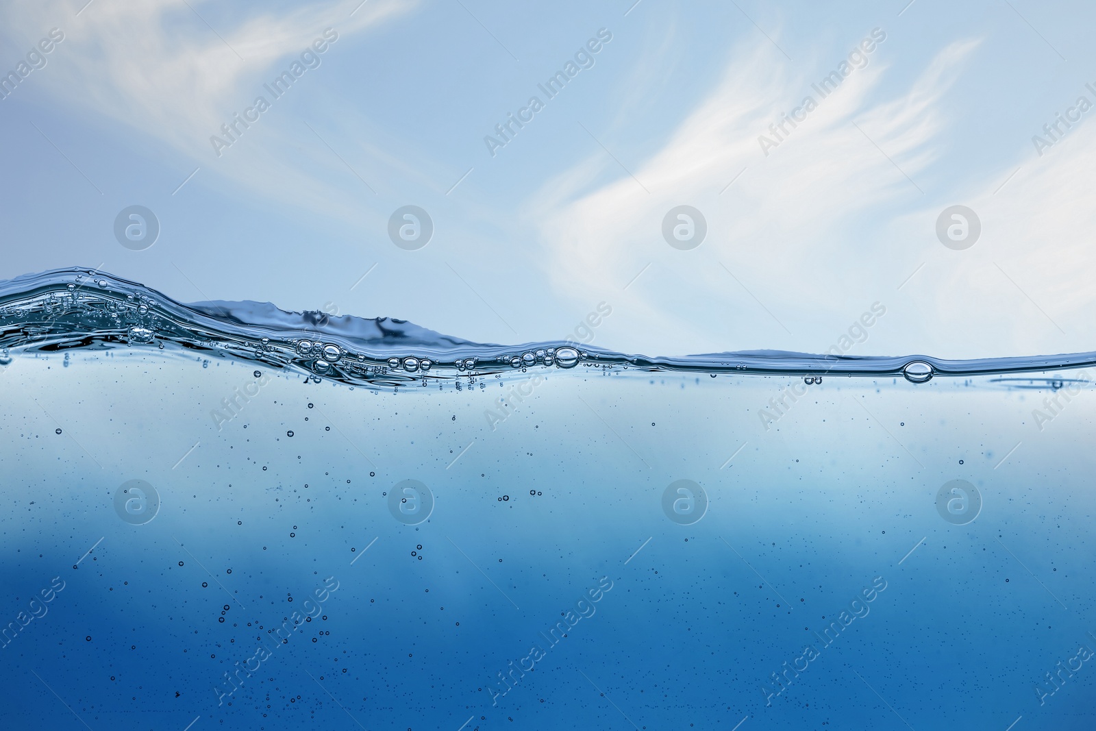 Image of Sea water surface and underwater view. Sky with clouds above
