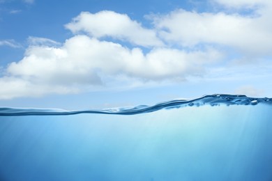 Image of Sea water surface and underwater view. Sky with clouds above