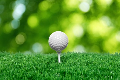 Image of Golf ball on green grass against blurred background