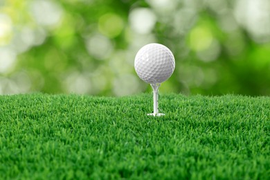 Image of Golf ball on green grass against blurred background