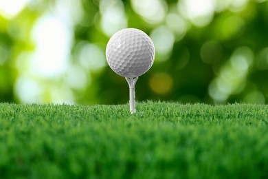 Image of Golf ball on green grass against blurred background