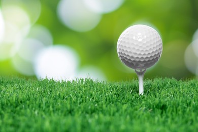 Image of Golf ball on green grass against blurred background
