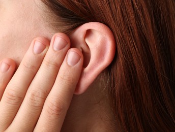 Photo of Sound. Woman touching her ear, closeup view