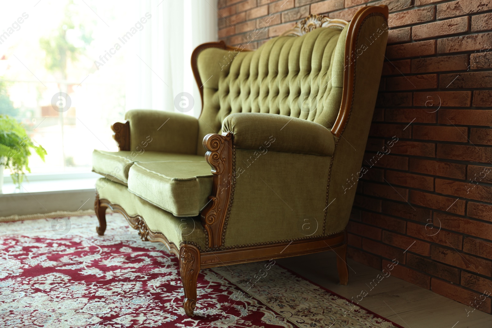 Photo of Green retro sofa in room. Interior design