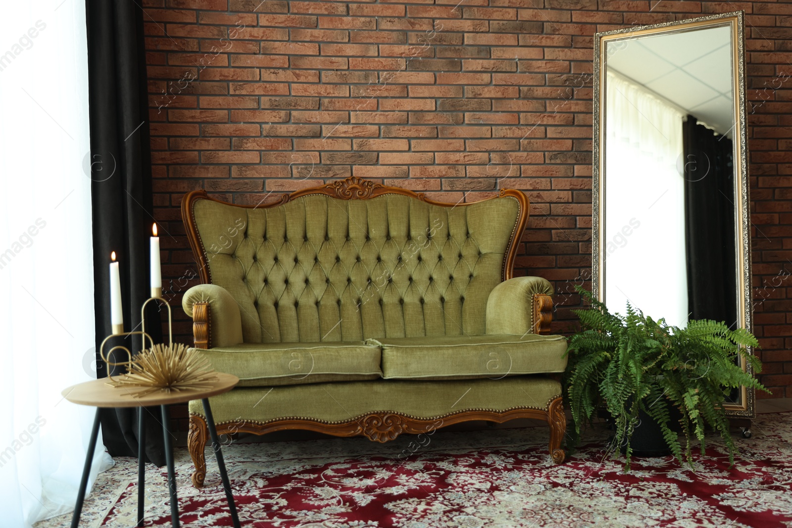 Green retro sofa, mirror, decor and houseplant in room. Interior design Photo of Green retro sofa, mirror, decor and houseplant in room. Interior design