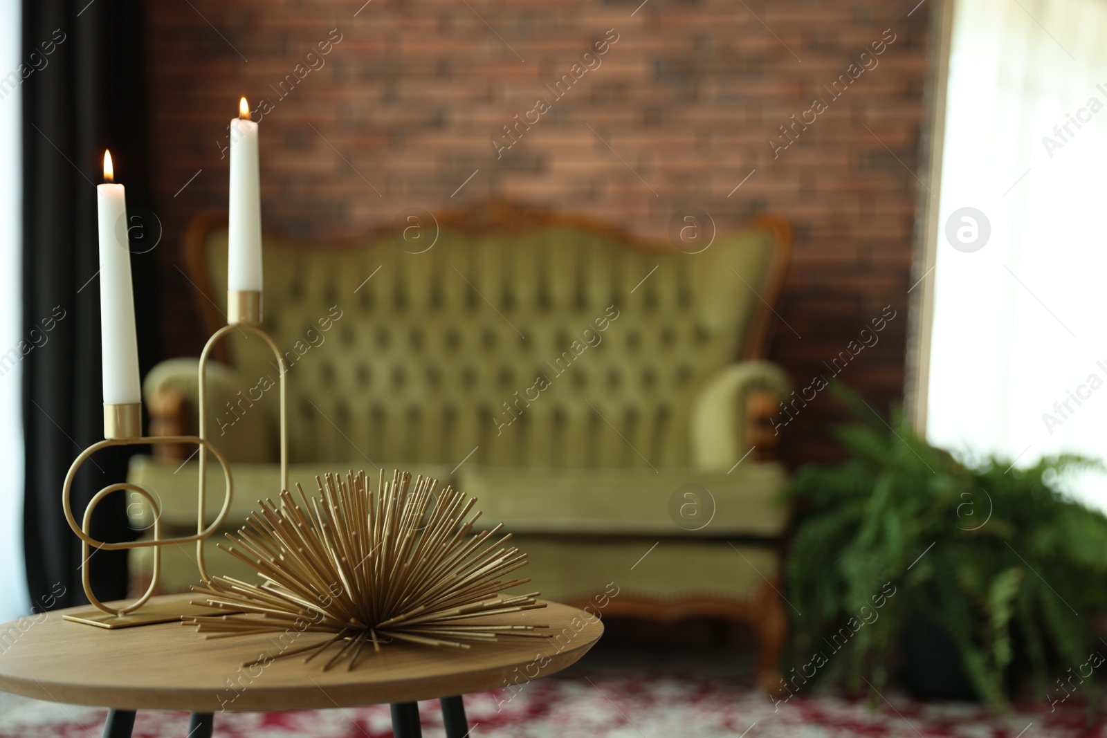 Photo of Coffee table with decor, vintage sofa and houseplant in room, selective focus